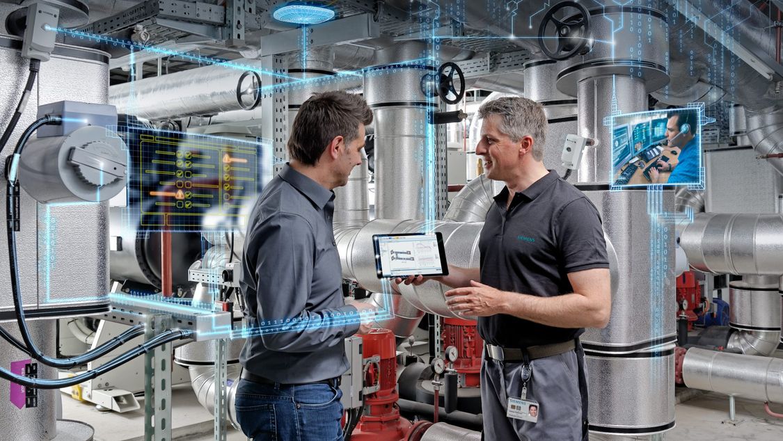 Two men in mechanical room looking at tablet