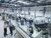 Businessmen in a digital manufacturing plant
