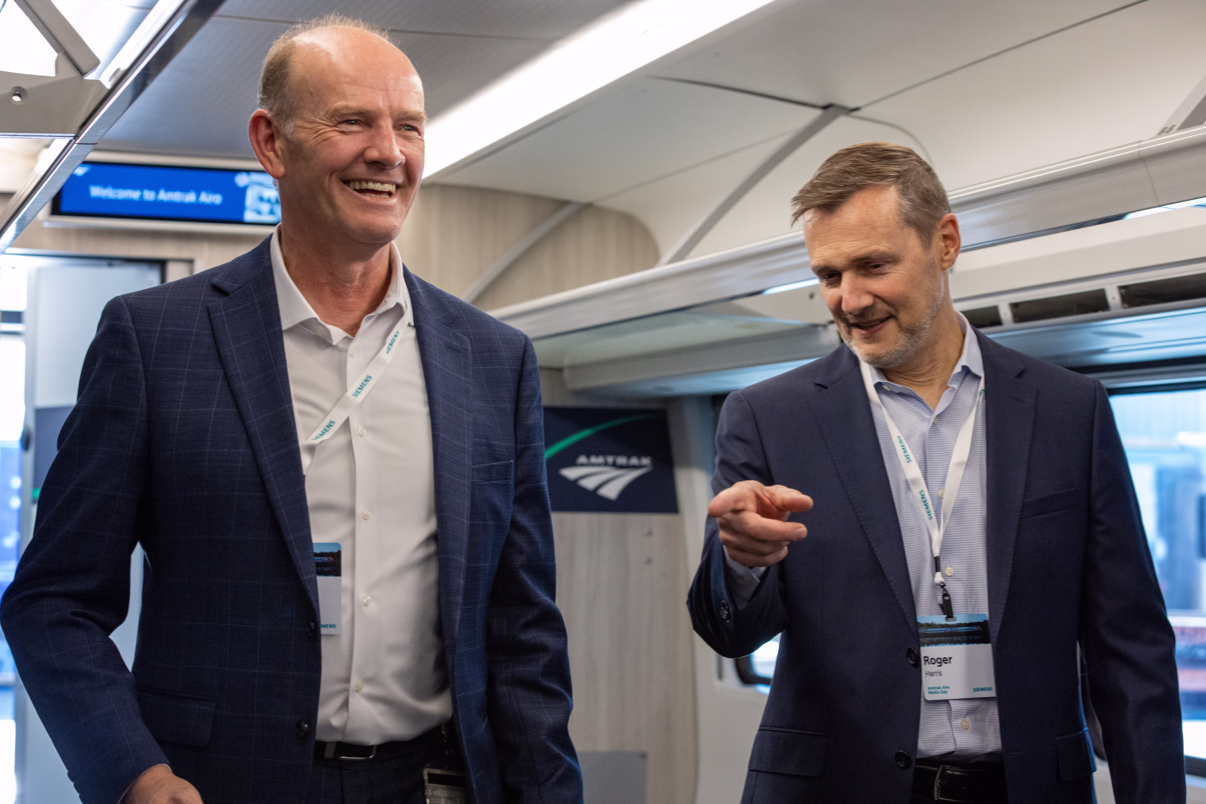 Two men talking to each other Amtrak Event