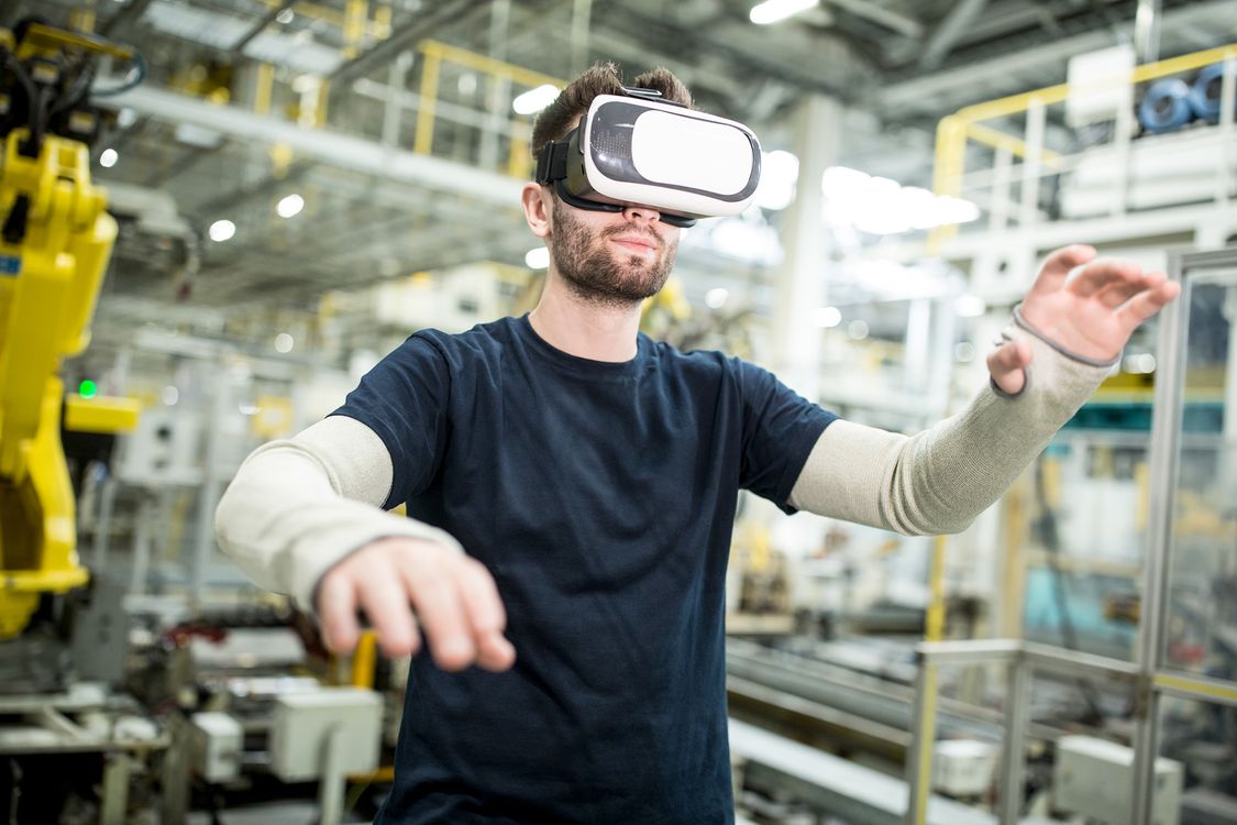 man using VR headset in a factory