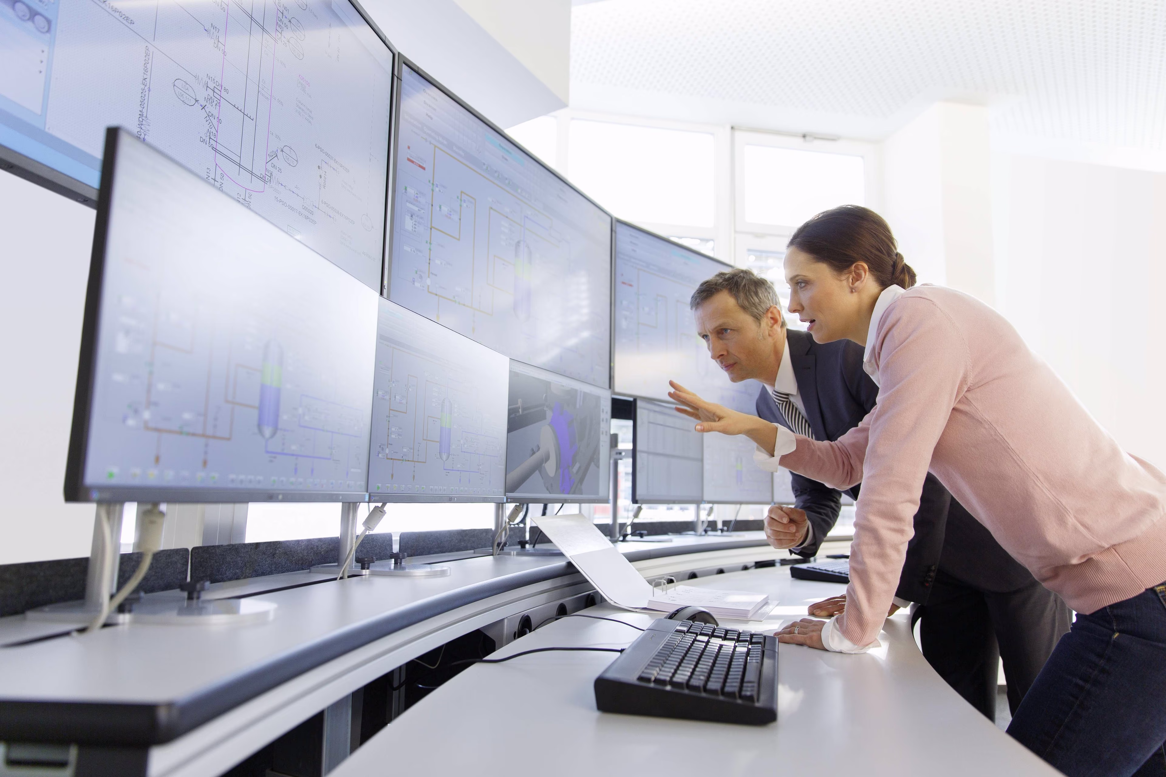two people in front of screens SCADA control center