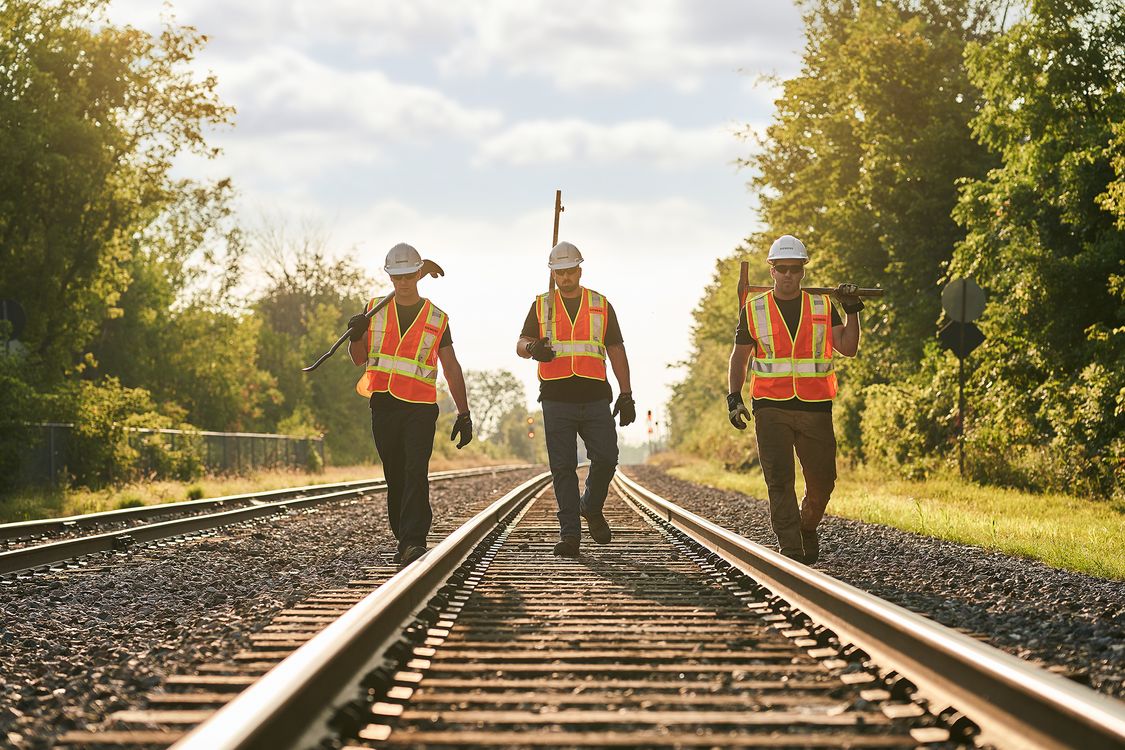 Rail workers walking on railway tracks