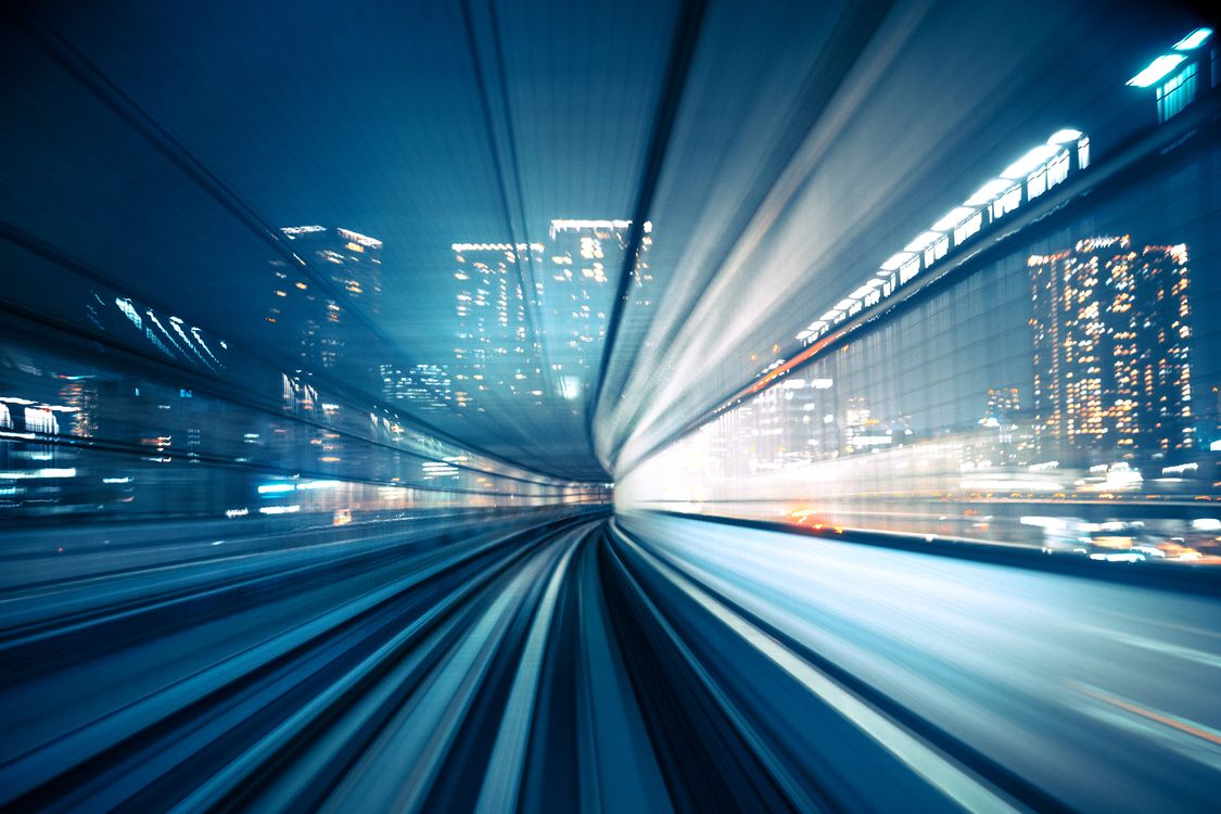 Fast moving train blurred in city 