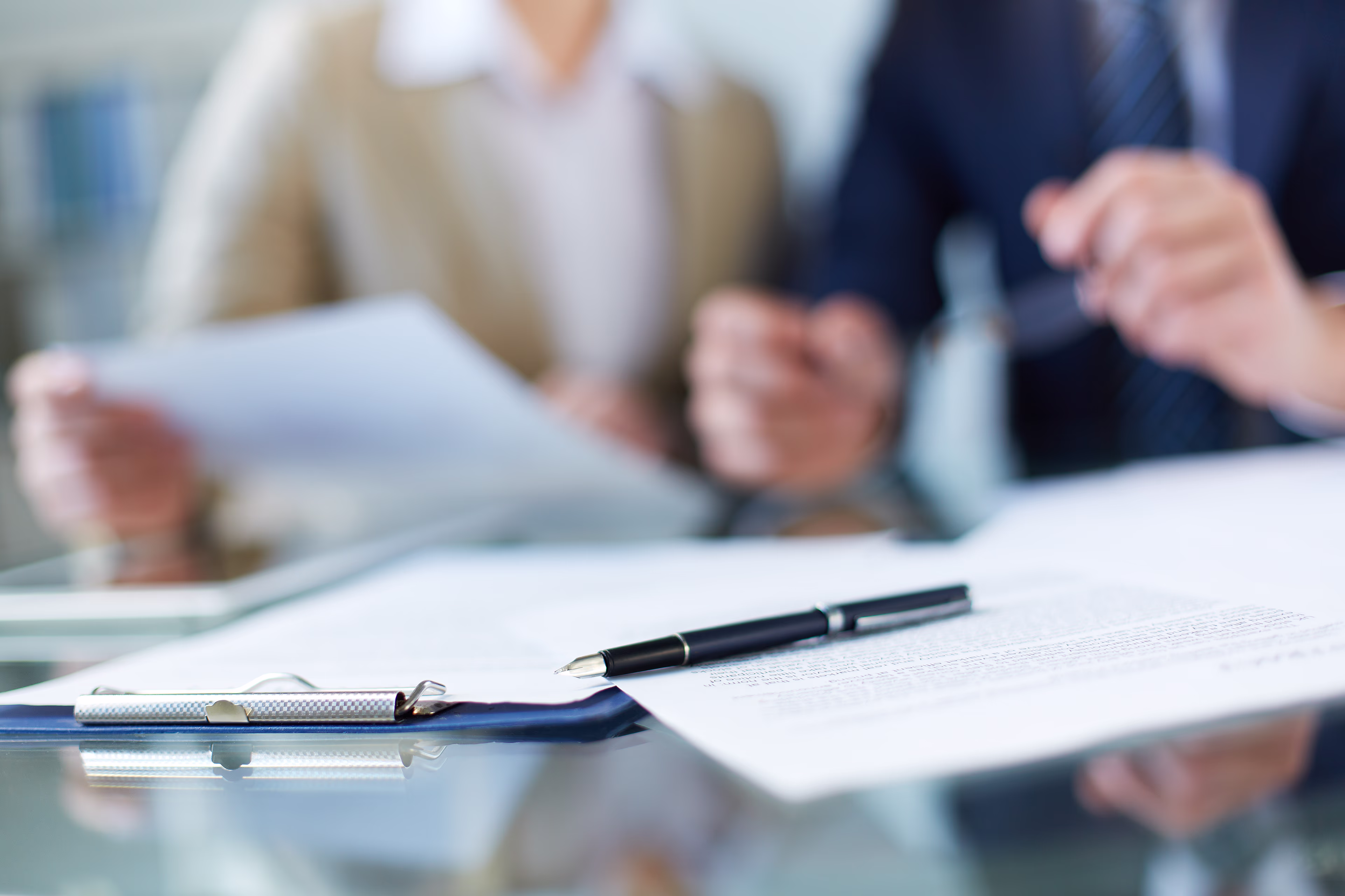 Business documents and a pen on a conference table. Siemens Mobility Business Partner