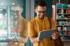 two men discussing information on a tablet Siemens efficient and predictable campus operations