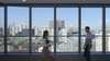 Siemens employees in front of office window with impressive skyline in the background