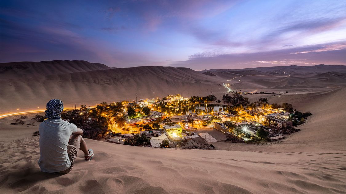Picture of an illuminated city in a remote desert