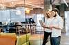 Woman and man are standing in the office looking at a laptop