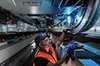 Service technician from Siemens Mobility Rail Services at work beneath a rail vehicle – checks the track wheel