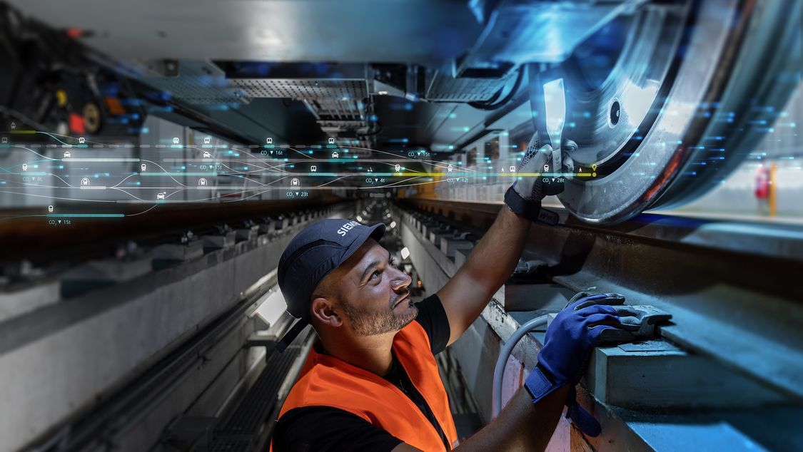 Service technician from Siemens Mobility Rail Services at work beneath a rail vehicle – checks the track wheel