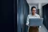 Female IT engineer doing diagnostics in server room Capture security status in buildings