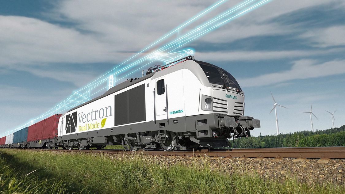 The Vectron Dual Mode in diagonal view on the track. An overhead line is shown in digital style .