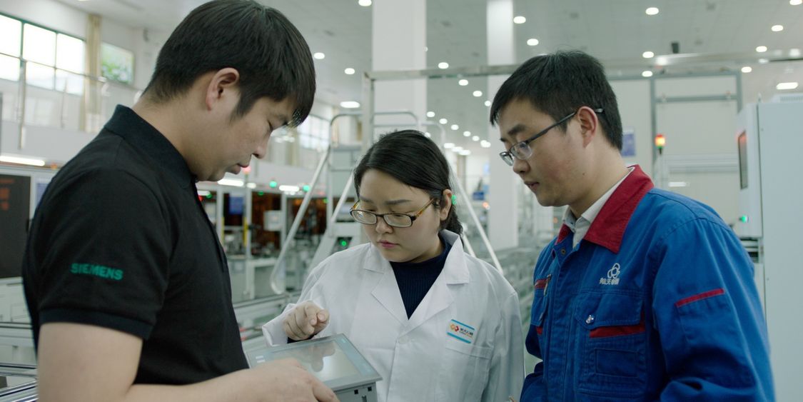 Many of the talents, like Lyu Jiangtao (right), trained in the project are now taking lead roles in other intelligent manufacturing projects