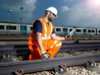 Man servicing a rail track with iPad in his hand 