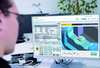 A man looks at a monitor running Run MyVirtual Machine. Run MyVirtual Machine