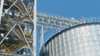 View from underneath on a tank farm in the right half of the photo, and at the left a staircase from the Biowind production facility in Cathay