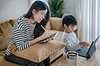 Mother and son working together at home